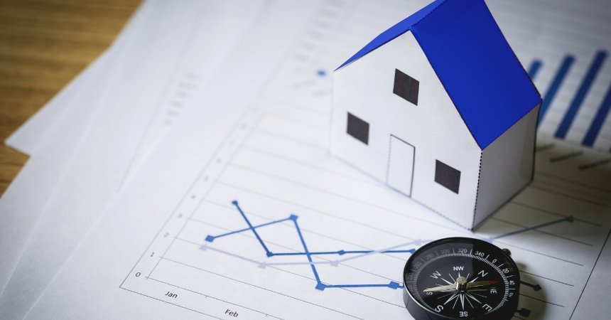 House model on property market charts representing Sydney’s housing affordability challenges and investment trends in 2026.